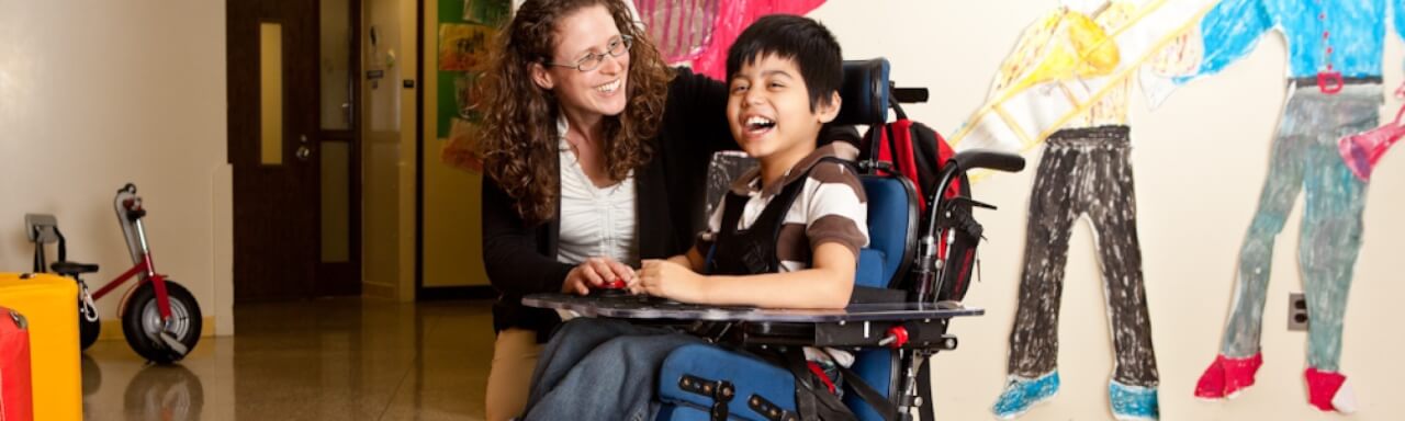 Adult with child in wheelchair